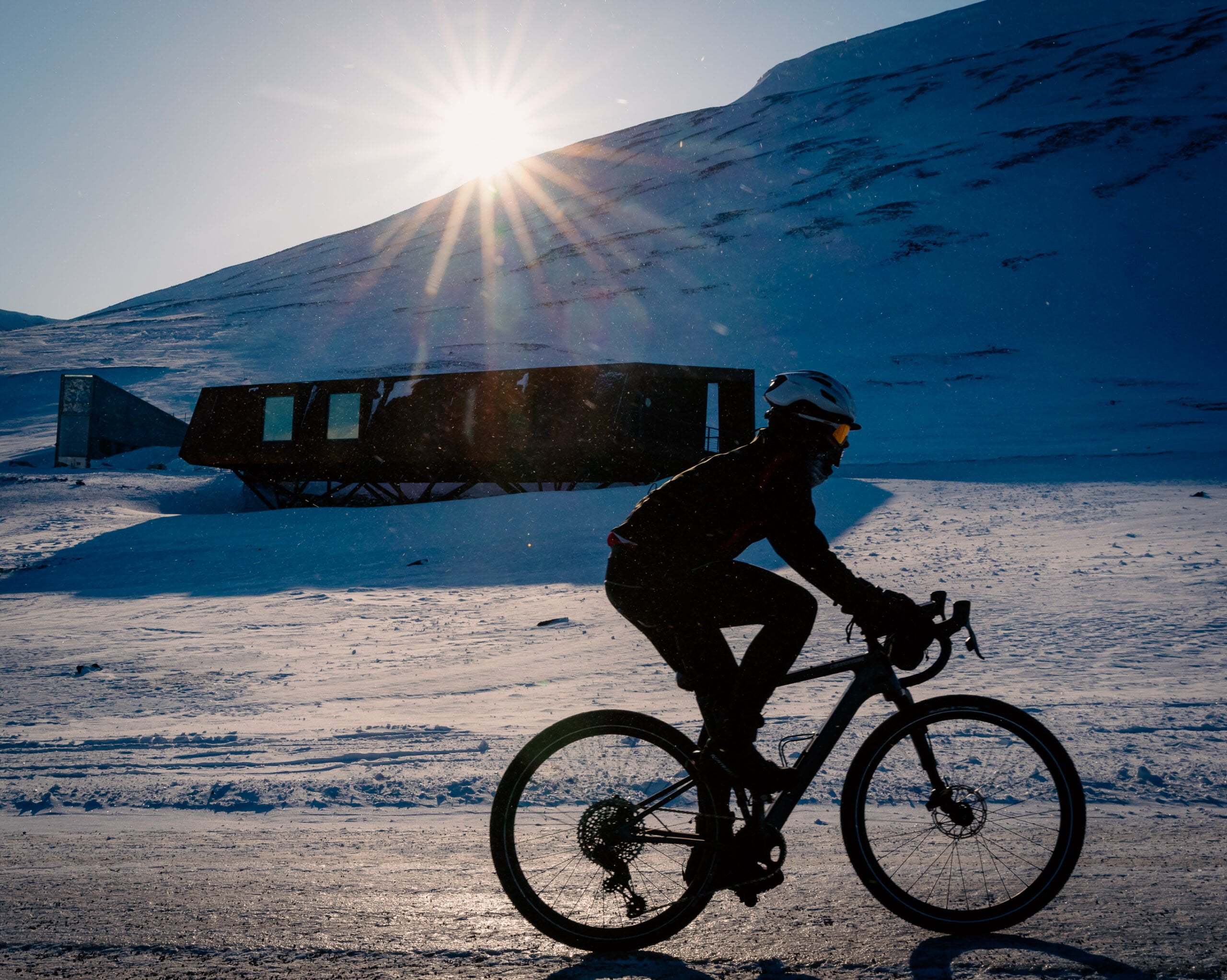 cyclist riding passed the Svalbard Global Seed Vault.
