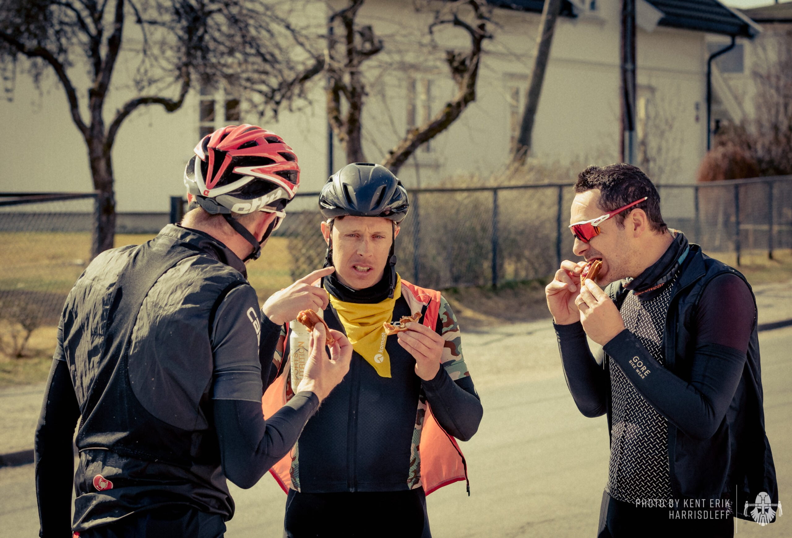 Three riders eating during the ride.