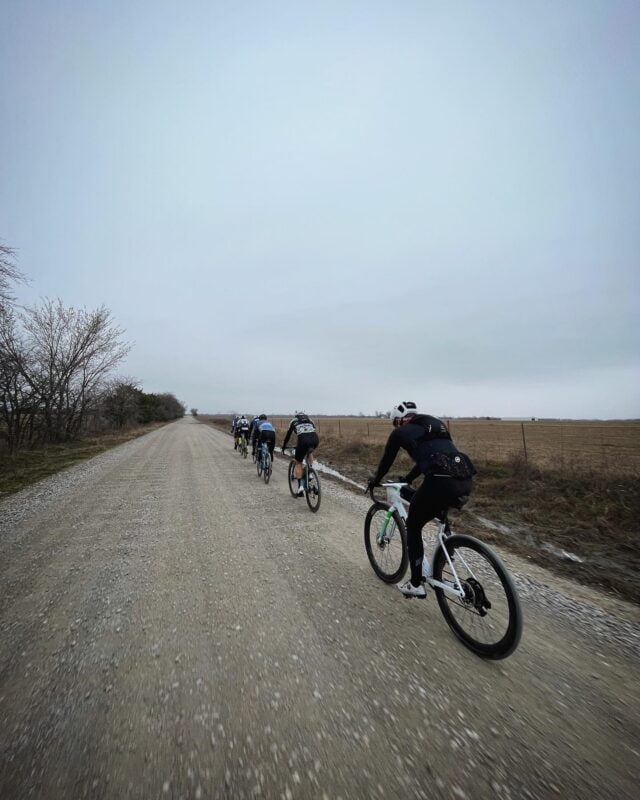 Group of riders on gravel road.